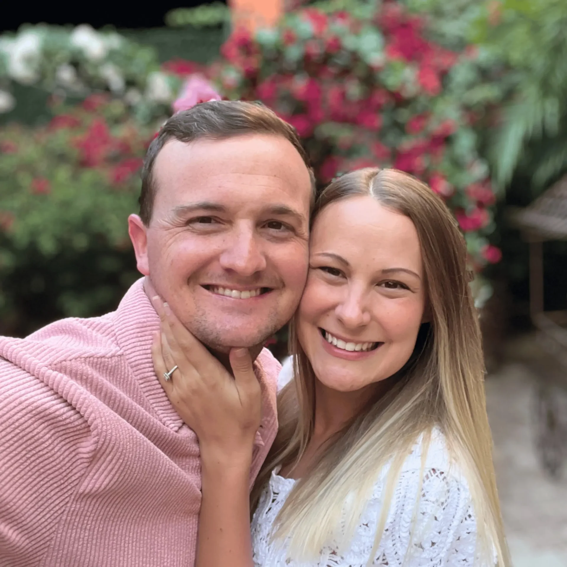 Jamie and Sarah McCauley, founders of Open Water, smiling together in a garden