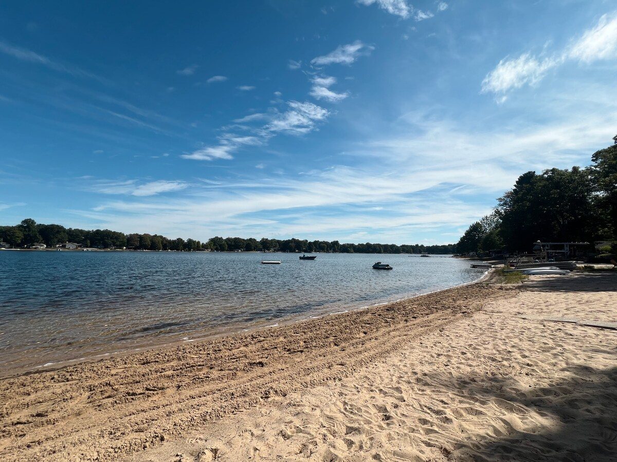 A wide sweep of sandy Lake Michigan beachfront at the MCM Lake House in Twin Lake, an Open Water co-hosted home